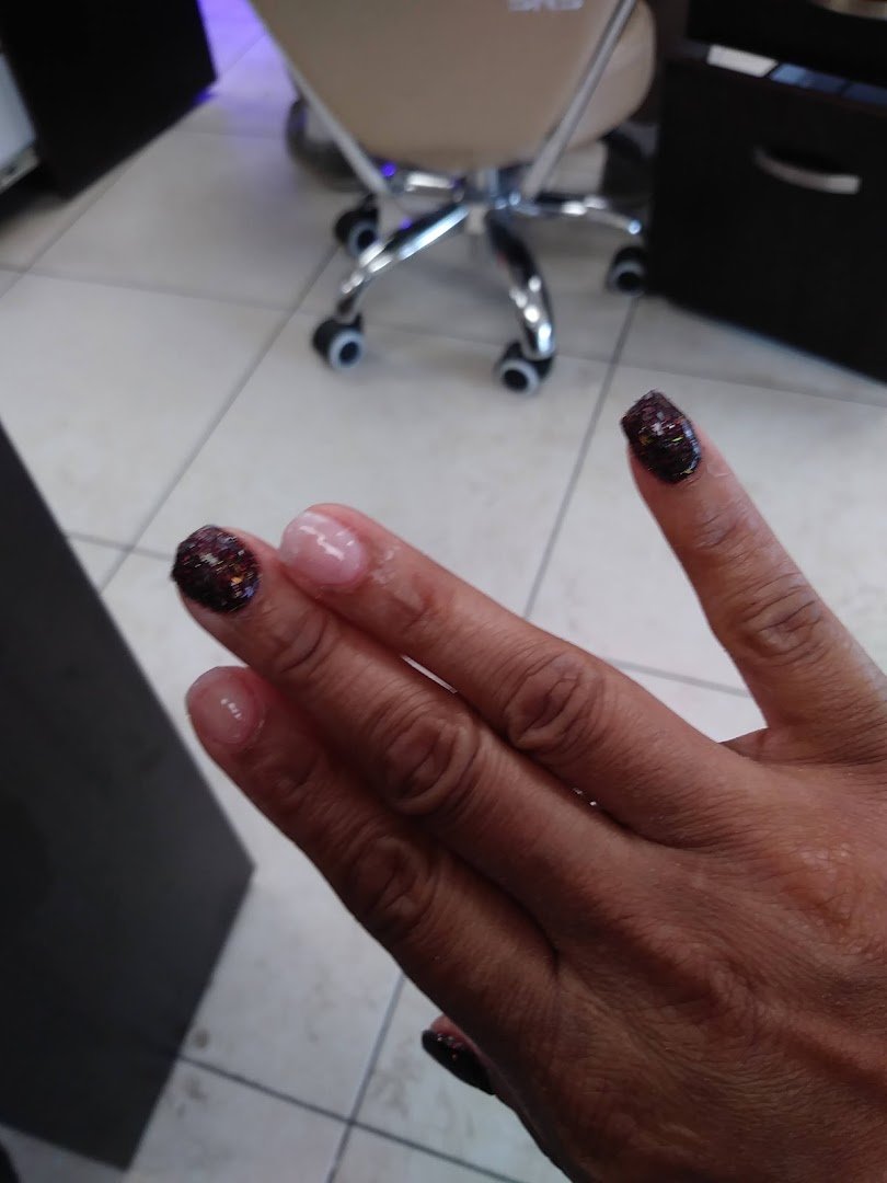 Acrylic nails displayed near a salon workstation.